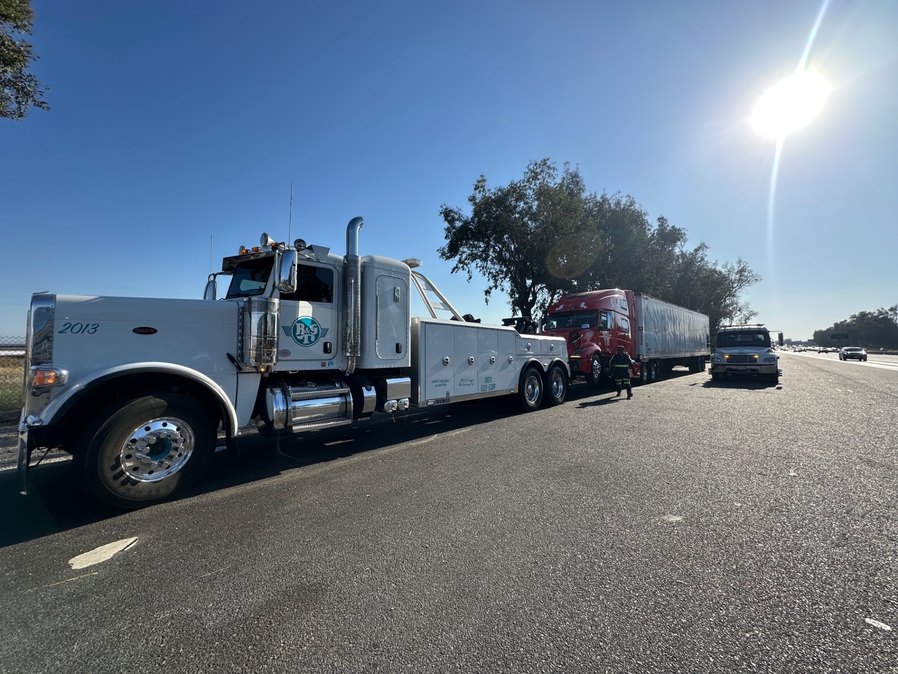 B&G Towing operator hooking up commercial truck